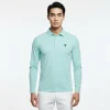 男模特兒穿tiffany色長袖涼感防曬 POLO 衫，搭配白色休閒褲。衣服左胸印有深藍色KOMIA註冊商標LOGO，背景為純白色。